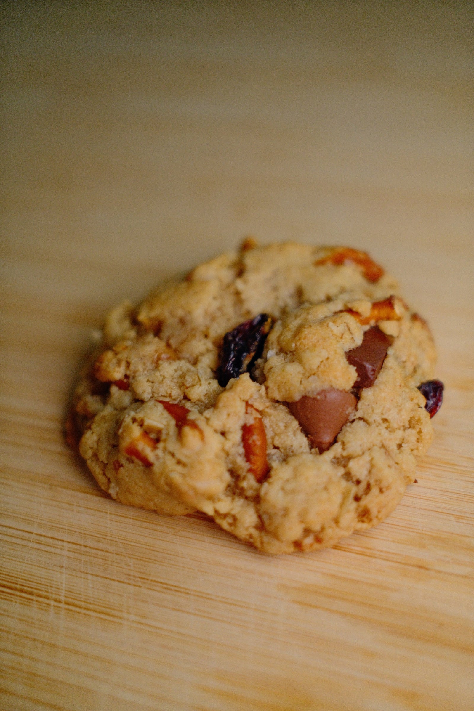 The Everything cookie up close, showing dried cherries, pretzel pieces, oats and chocolate